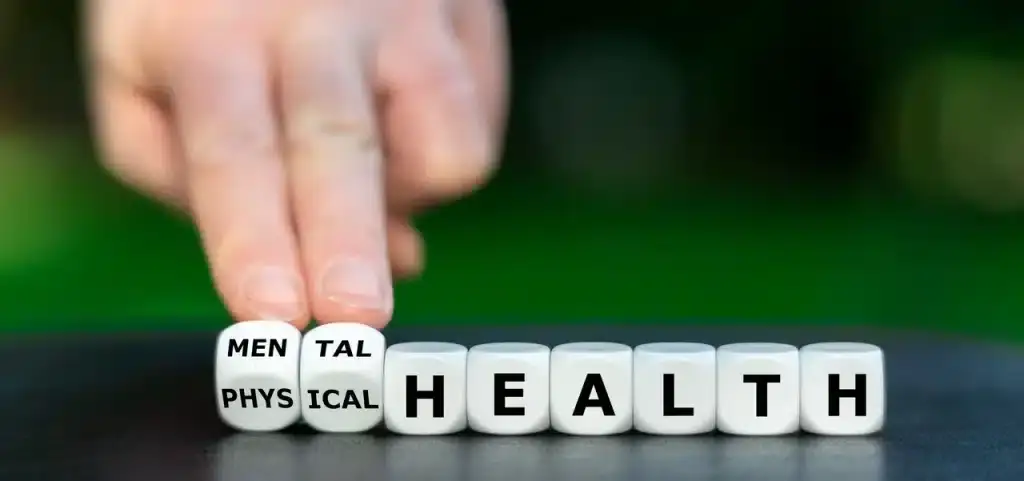 A line of cube letters spelling out health, with two cubes in front with mental on them.