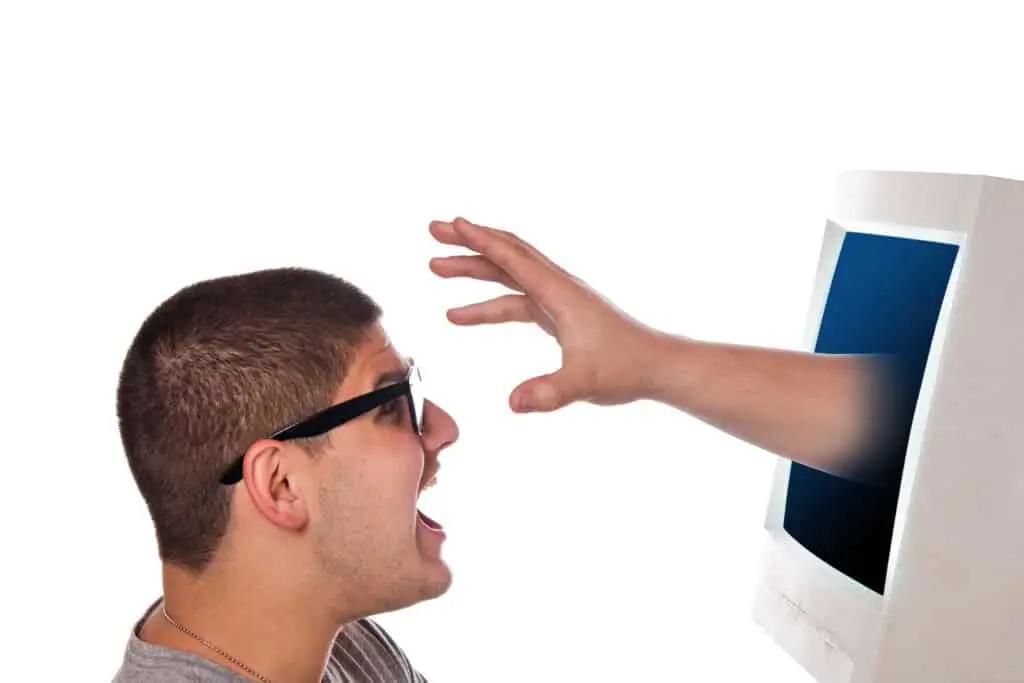 A man protectively reaching for a computer screen, protect your identity