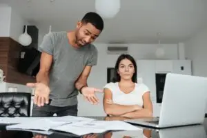 A man and woman reviewing papers about the impact of debt.