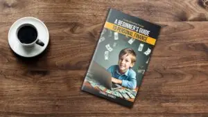 A book titled "A Beginner's Guide to Personal Finance" with an image of a smiling child surrounded by money, placed on a wooden table next to a cup of black coffee, illustrating the importance of financial literacy in achieving a well-rounded life.