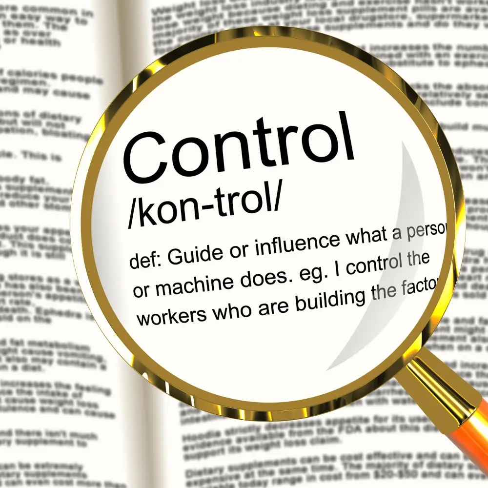 A magnifying glass enlarges the word "Control" and its definition in a dictionary, stating: "Guide or influence what a person or machine does. eg. I control the workers who are building the factory, much like managing financial habits to ensure efficient money flow.