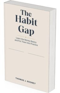 A book titled “The Habit Gap” by Thomas J. Rooney, with the subtitle “Learn the Money Basics and Put Them into Practice,” is standing upright against a white background, inviting readers to discover Simple Money Habits for everyday financial success.