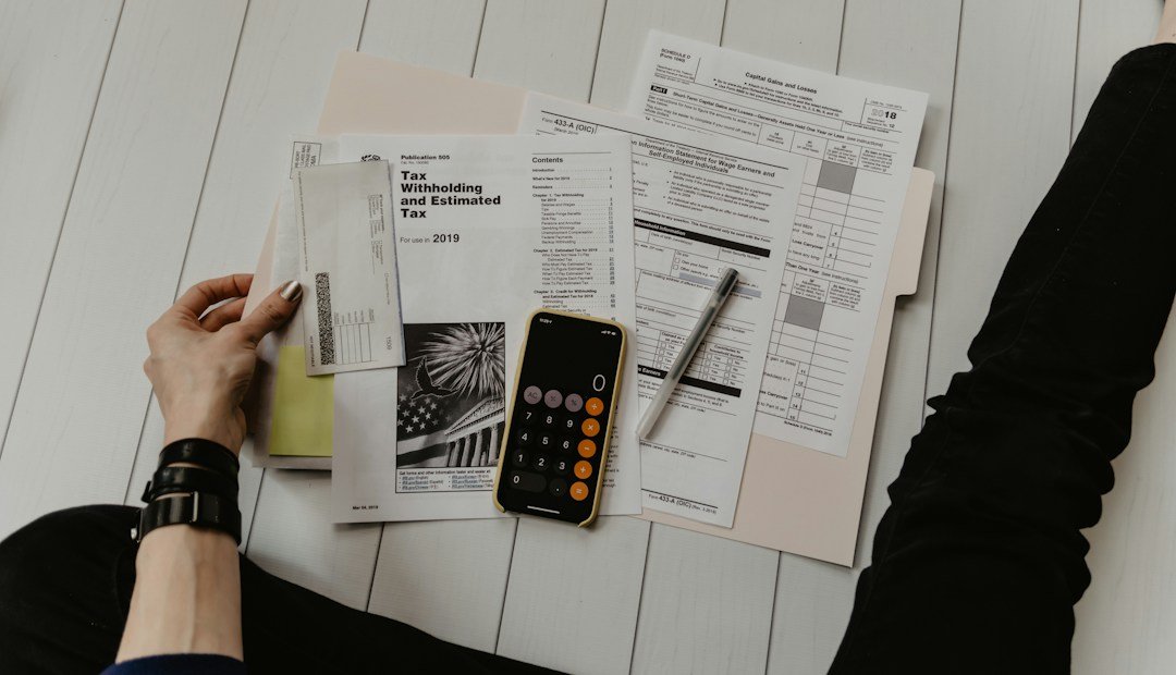 Need to borrow money? Reviewing paperwork beside a pen and calculator