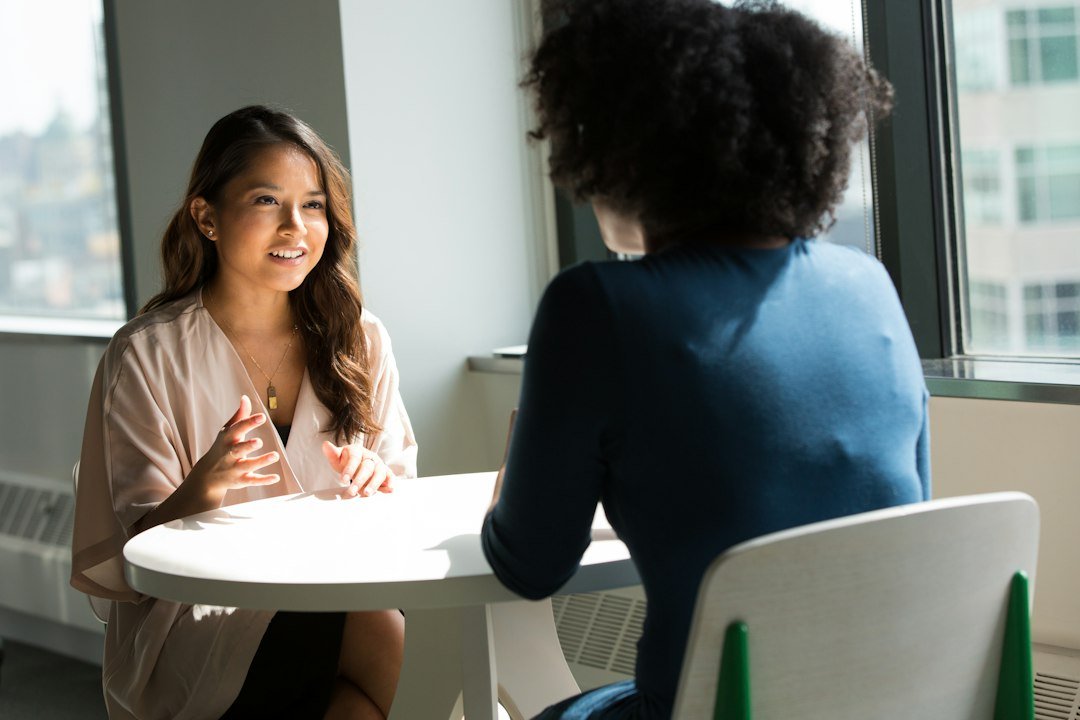Discussing Money: How to Make an Uncomfortable Conversation Easier 1 Two women in conversation, illustrating a respectful approach to discussing money