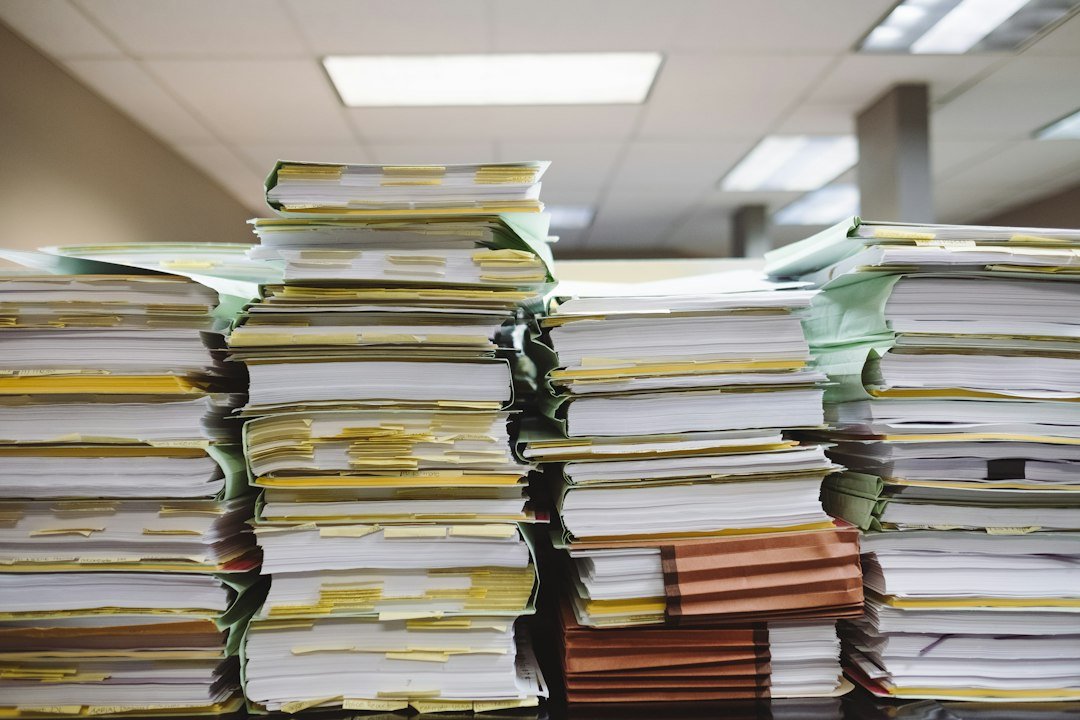 Paper documents and folders to organize when reviewing financial security